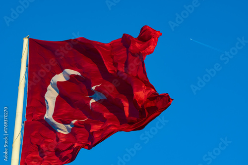 Waving Turkish Flag isolated on blue sky