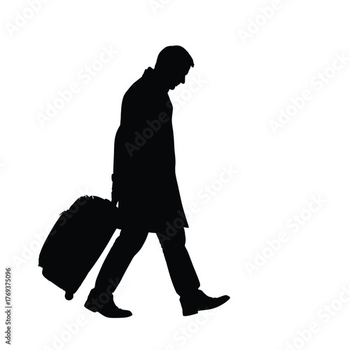 Silhouette of a man walking with a rolling suitcase