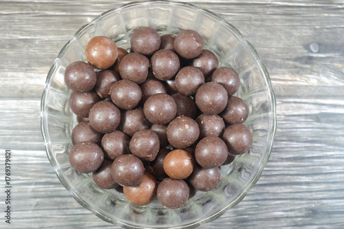 Canvas Print bowl of chocolate-coated peanut, a confectionery made of a roasted peanut covere