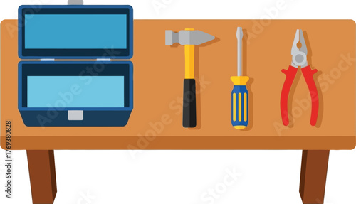 A toolbox sits open next to a hammer, screwdriver, and pliers on a wooden workbench.