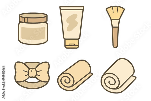 Minimalist set of cosmetic containers, makeup brush, hair accessory, and rolled spa towels