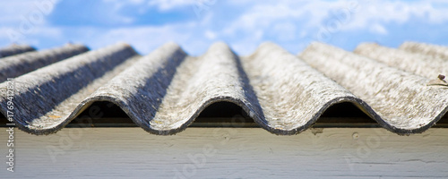 OLD AGED AND DANGEROUS ASBESTOS ROOF made of prefabricated and wave-shaped panels - Web banner design concept