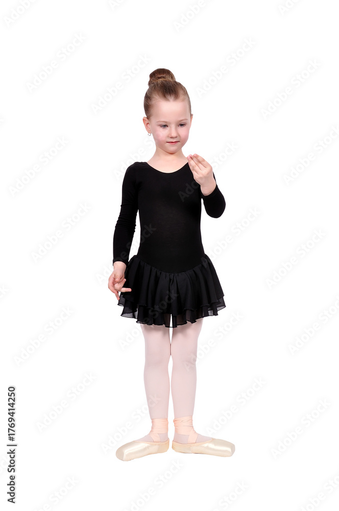 Fototapeta premium Young girl in ballet pose wearing a black tutu