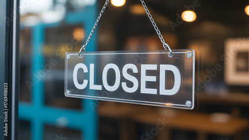 Closed Sign in Storefront Window: A close-up view of a 'Closed' sign hanging on a glass door, conveying a sense of finality and unavailability.
