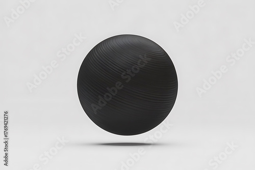 A textured black sphere floats against a plain white background, creating a minimalist, abstract composition.