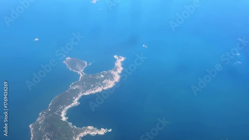 Aerial view of a narrow island surrounded by turquoise sea