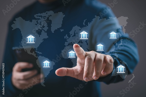 A person using smartphone with digital bank icons on a world map interface. Concept of global banking, fintech, international finance, online transaction, and digital financial services.