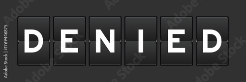 Black color analog flip board with word denied on gray background