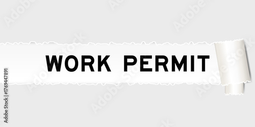 Ripped gray paper background that have word work permit under torn part
