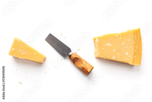 Parmesan cheese wedge, cut, with a cheese knife, isolated on a white background, overhead flat lay shot