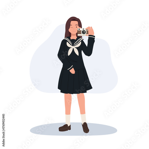 a girl in school uniform holding a camera. A smiling young girl in sailor suit with a camera. Japanese school girl.