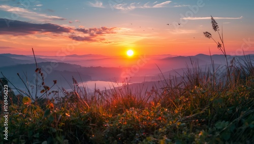 Stunning sunrise over mountain range with vibrant colors and birds flying