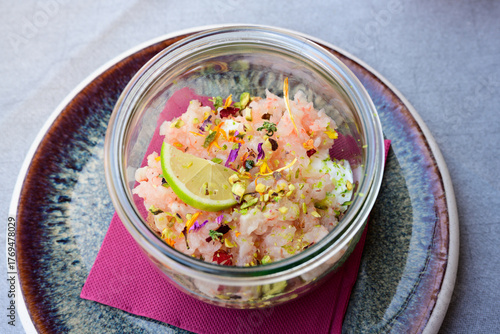 Red Prawn Tartare with Raw Shrimp, Lime, Edible Flowers in Italian Tartare di Gamberi Crudi