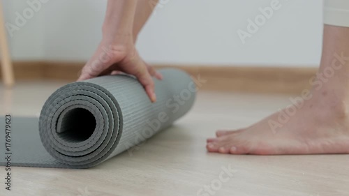 Slim woman practicing yoga on room at condo or home. Asian woman keep yoga mat. balance, meditation, relaxation, calm, good health, happy, relax, healthy lifestyle, diet, slim