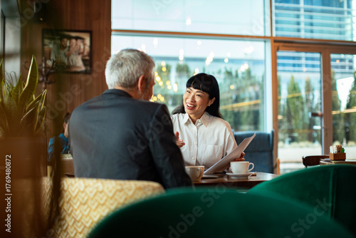 Businessman and businesswoman having a meeting in a cafe