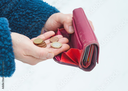 Fototapeta Pink purse and euro coins in a woman's hands, selective focus.