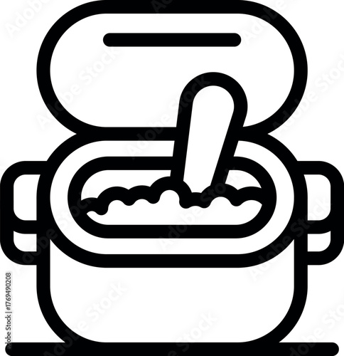 Baby food is being prepared in a container with a spoon, perfect for illustrating infant nutrition and meal preparation