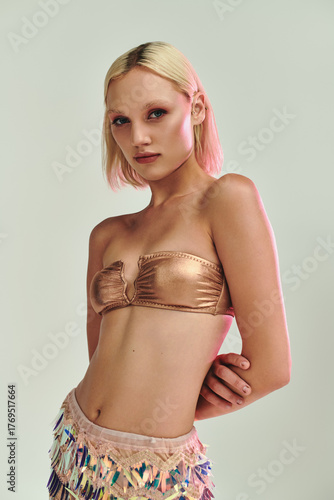 Wallpaper Mural Blonde young woman in stylish party outfit showcases holographic elements in studio Torontodigital.ca