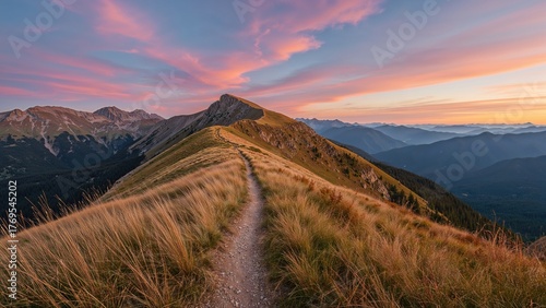Fototapeta Naklejka Na Ścianę i Meble -  Mountain trail leading along the mountain ridge of beautiful mountains with autumn grass and colorful sky.