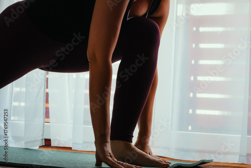 Real body woman doing yoga and fitness workout at home, showing authentic lifestyle, strength and self-care in everyday environment.