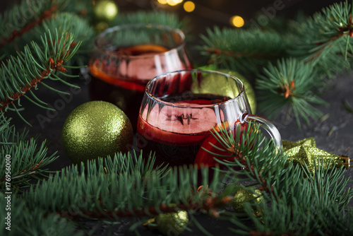 Two Glass Mugs of Mulled Wine with Christmas Decor and Fairy Lights