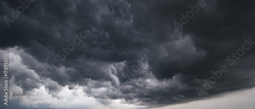 Dark storm clouds gathering in the sky, symbolizing danger, power, and dramatic weather before heavy rain or thunderstorm. Perfect for concepts about nature, climate change, and emotional tension.