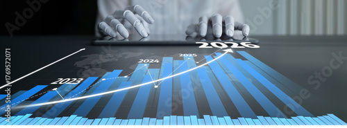 Schilderij op canvas A business professional hands interact with a tablet displaying graphs that represent growth projections from 2023 to 2026, illustrating data analysis and trends