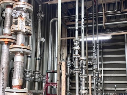 Принти на полотні Complex industrial pipework and flanged connections inside a large processing plant