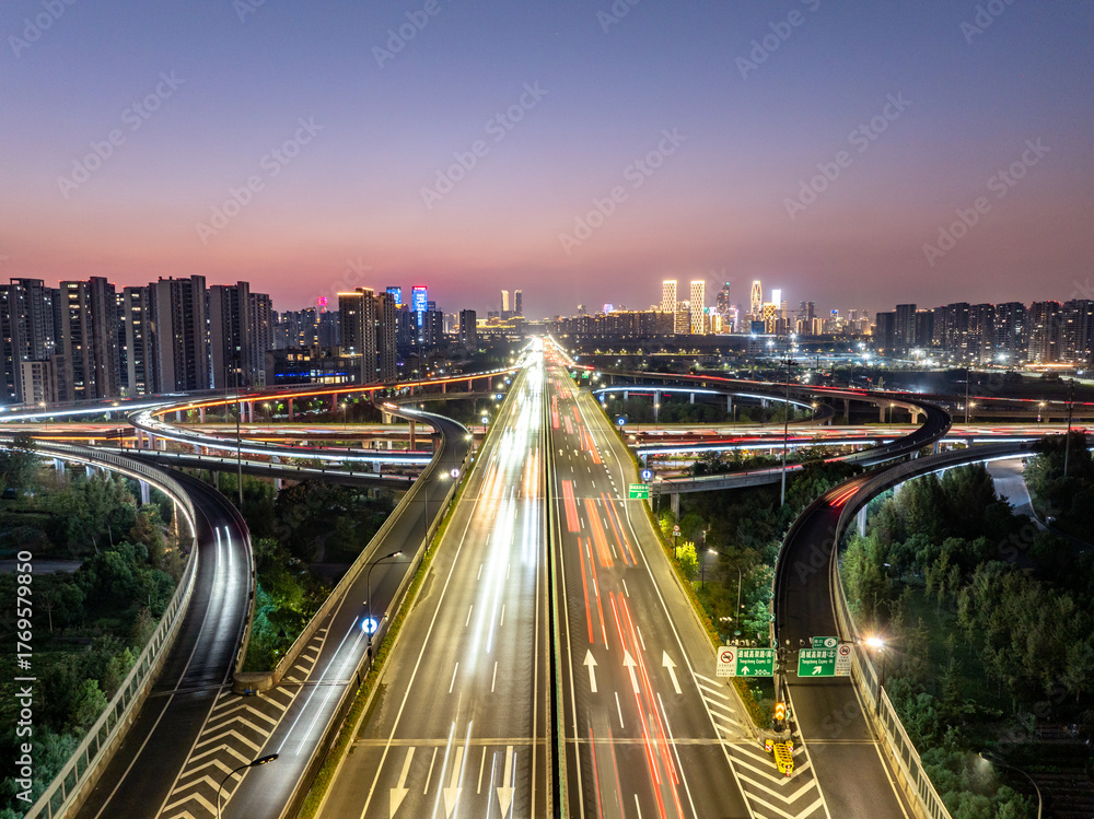 Fototapeta premium Aerial views of urban highways and interchanges at sunrise