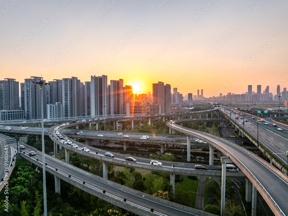 Obraz premium Aerial views of urban highways and interchanges at sunrise