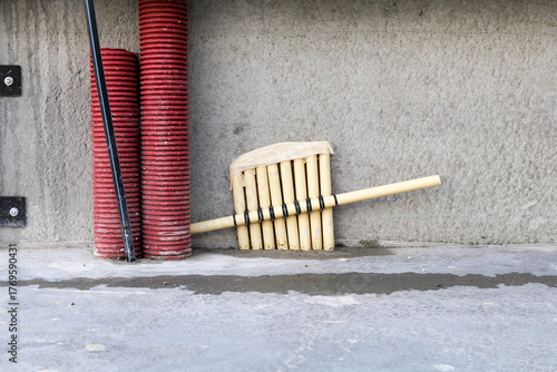 a bunch of electricity pipes and two big pipes at the edge of a shed in construction closeup