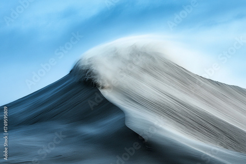 Fototapeta Naklejka Na Ścianę i Meble -  Wind blowing sand off the top of a sharp dune crest