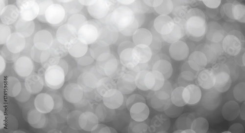 Abstract background of blurred white bokeh lights, creating a soft, dreamy, and magical effect with a shallow depth of field