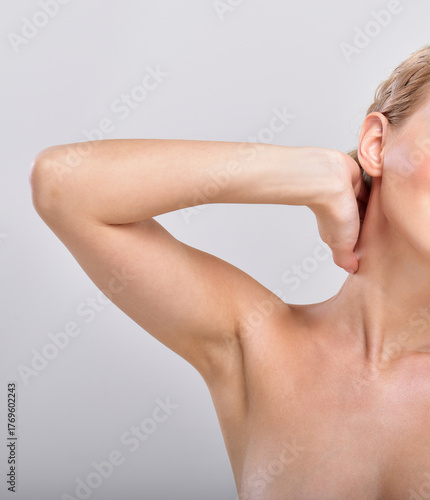 Beautiful young woman holding her arms up and showing clean underarms. Armpit's care. Armpit epilation, hair removal, perfect skin.