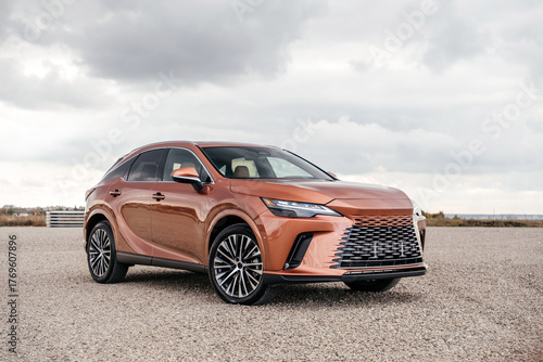 A premium, modern hybrid SUV with an elegant design, incredible color, beautiful wheels, and a large grille.