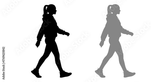 Silhouettes of a young woman walking presented in contrasting shades
