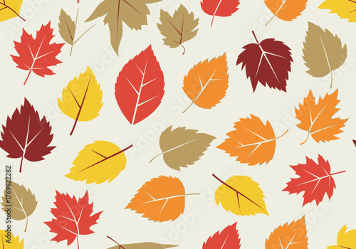 Colorful autumn leaves scattered on a light beige background, creating a seasonal pattern.