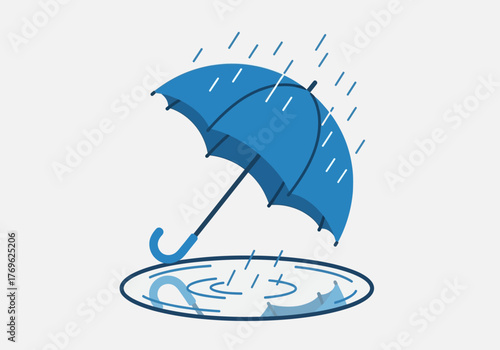 An open blue umbrella under falling rain with a puddle of water on the ground.