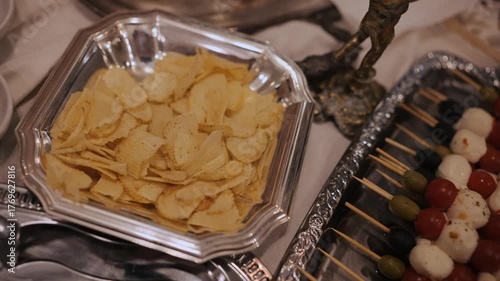 Beautifully served banquet table with different food snacks and appetizers. Afterparty