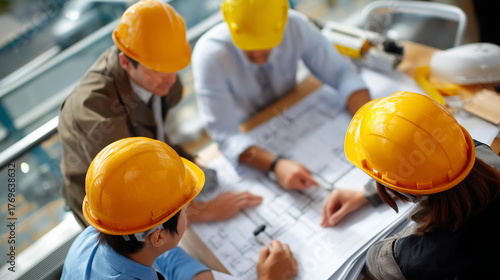 Top view of faceless engineer and architect team meeting around construction blueprints measuring building layout planning session construction site coordination project discus