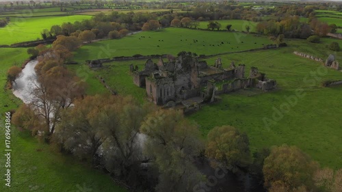 Discovering the enchanting ruins of a historic castle nestled in lush green fields and flowing rivers