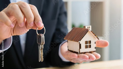 Wallpaper Mural Handing over house keys with a miniature house model, real estate ownership, home buying process, property investment, first-time homebuyers, housing market transactions, new home excitement Torontodigital.ca