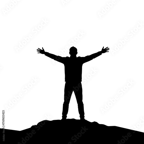 Silhouette of triumphant young male on mountain with outstretched arms
