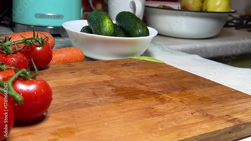 Lettuce leaves are thrown onto a wooden board. Slow motion shooting.