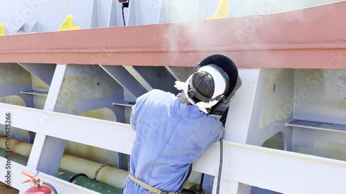 Ship welder working on cargo hold coaming at sea with sparks and smoke — maritime repair work scene, showing the hard and dangerous work of maritime engineering and maintenance. Realistic view of ship