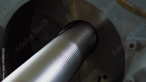 Automated production of uniform helical grooves on polished steel, metal hoses