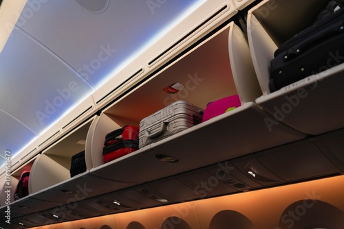 Airplane Overhead Storage Compartments Filled with Luggage – Travel Preparation