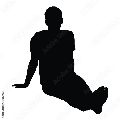 Silhouette of a young man sitting relaxed with legs extended outdoors silhouette