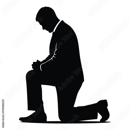 Silhouette of man in suit kneeling in prayer or contemplation silhouette