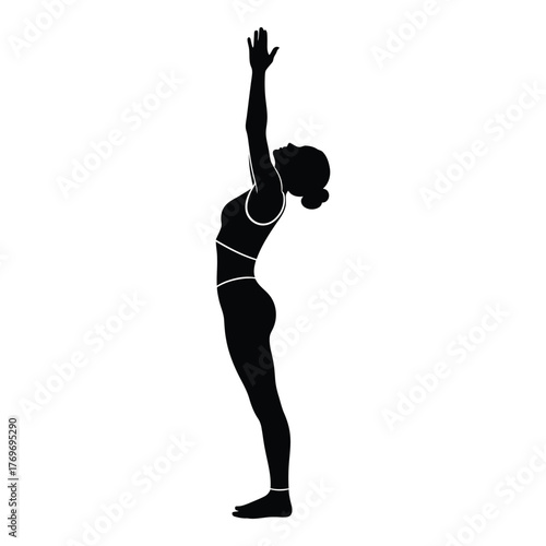 Silhouette of woman performing upward salute pose in yoga silhouette